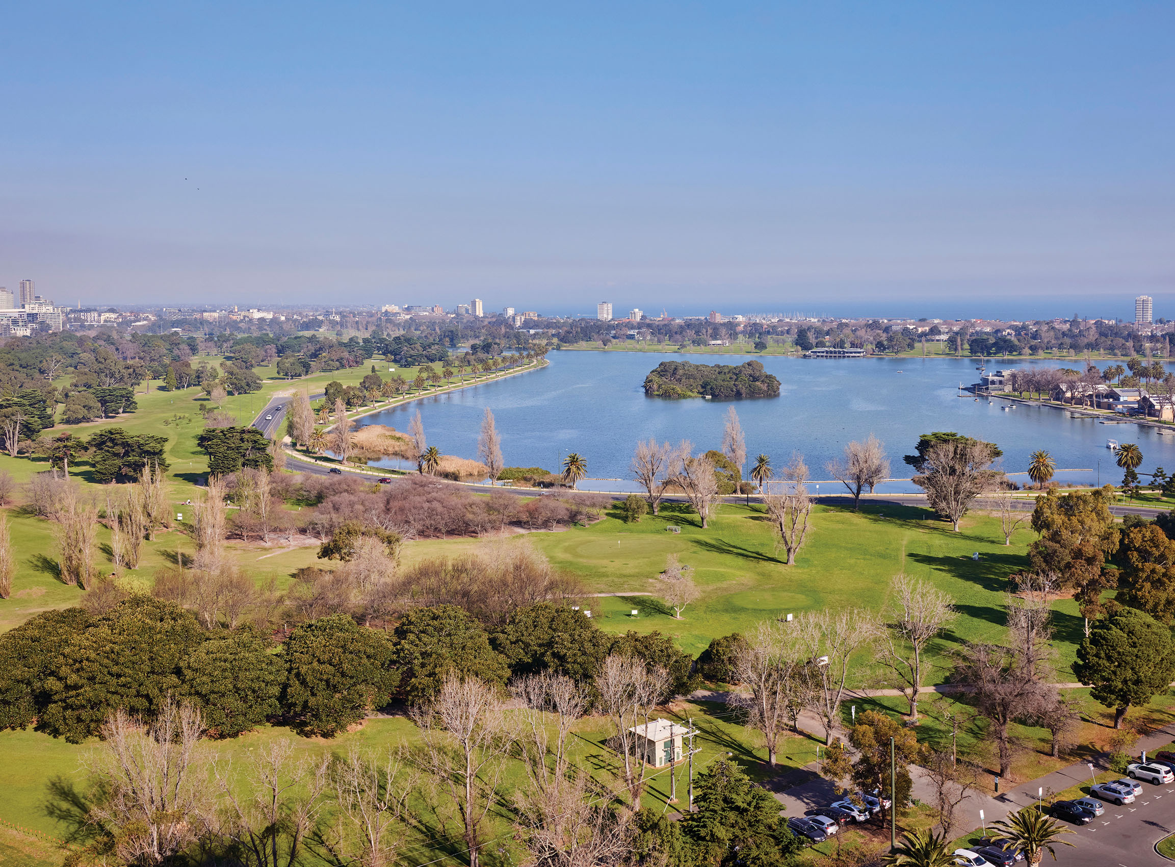 Panoramic vistas across Albert Park Lake and to Port Phillip Bay. 